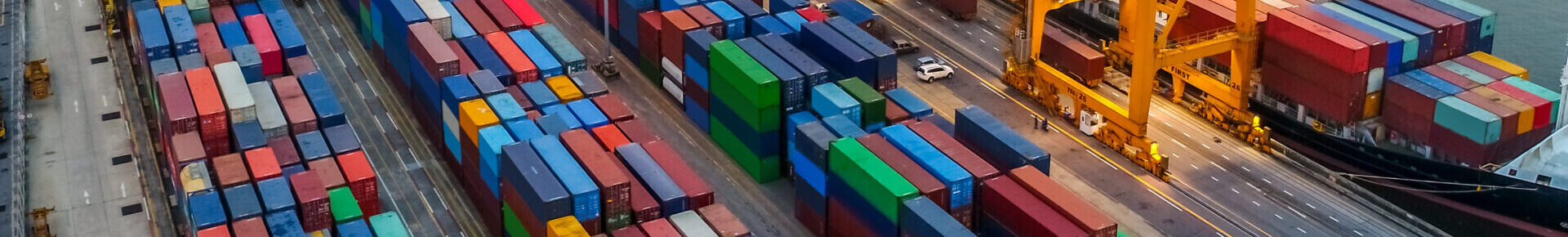 Logistics and transportation of Container Cargo ship and Cargo plane with working crane bridge in shipyard at sunrise, logistic import export and transport industry background