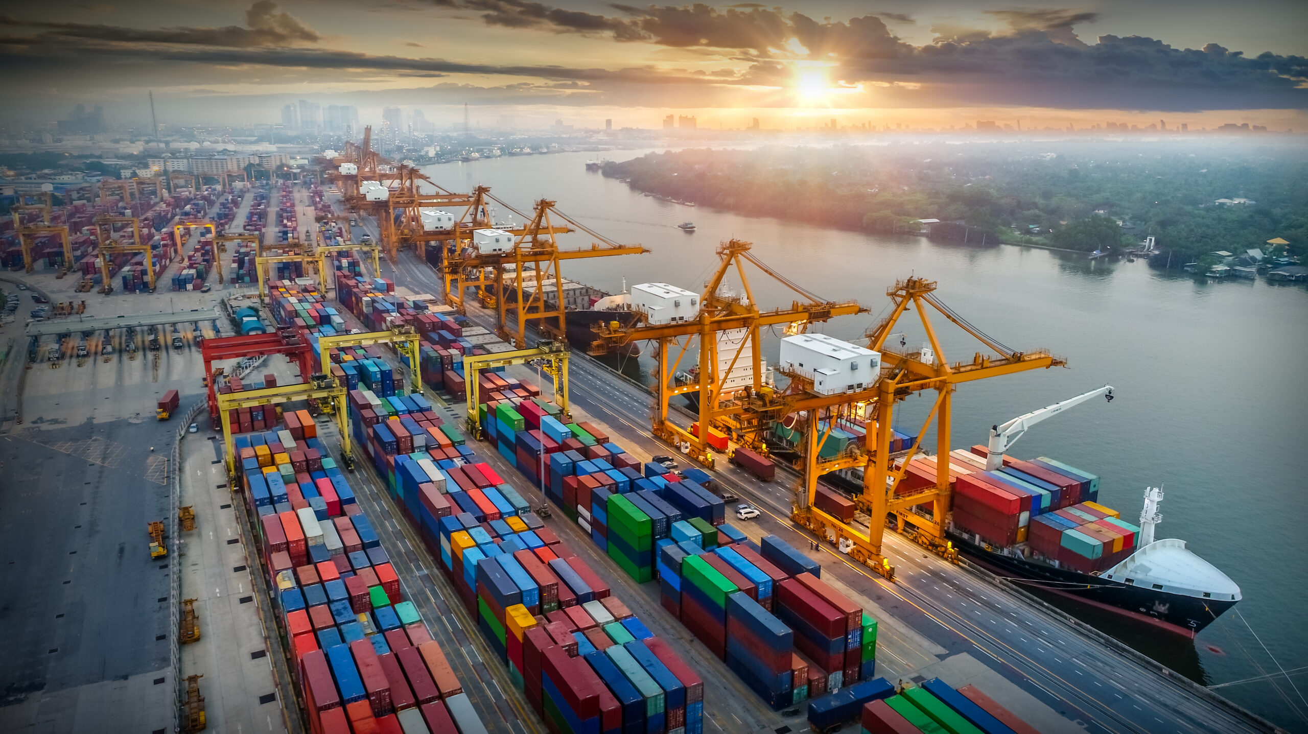 Logistics and transportation of Container Cargo ship and Cargo plane with working crane bridge in shipyard at sunrise, logistic import export and transport industry background